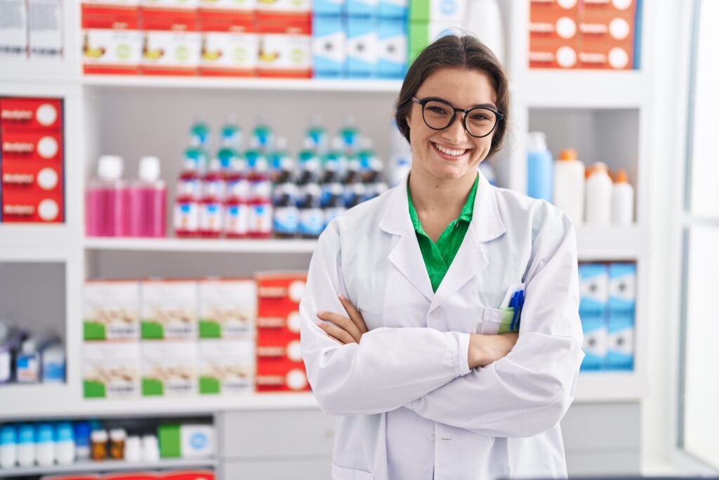 young-hispanic-woman-pharmacist-smiling-confident-standing-with-arms-crossed-gesture-pharmacy