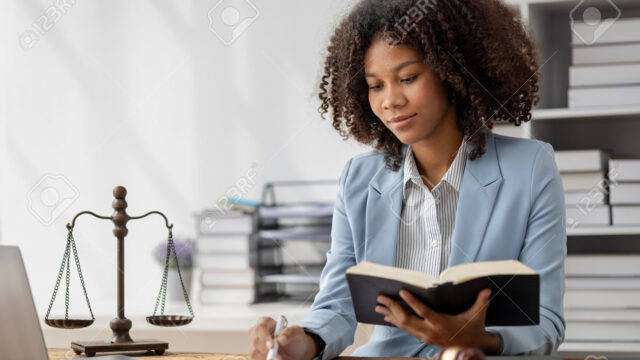 210478901-american-woman-is-legal-litigation-attorney-female-lawyer-is-in-a-law-firm-drafting-contracts-and